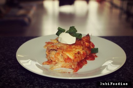 Chicken Enchiladas sered with sour cream and spring onions.